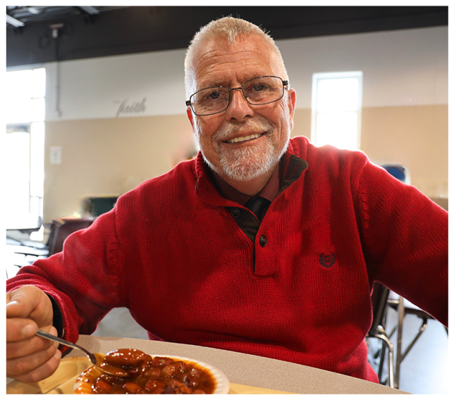 This is an image of a gentleman having a meal at Open Door Mission.